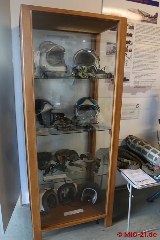 Equipment on display includes pilots' and technicians' helmets, ...