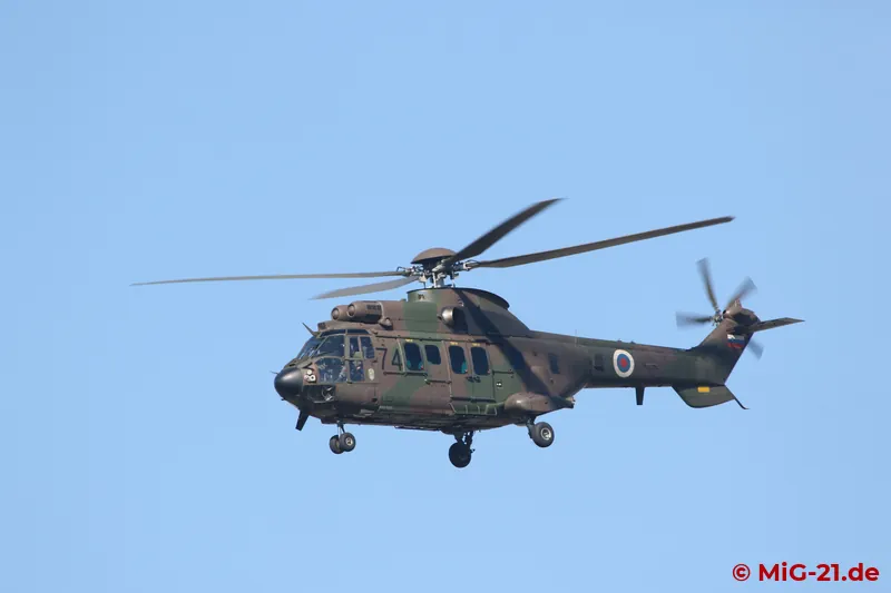 While waiting for a possible further test flight, a Slovenian Cougar makes a flypast.