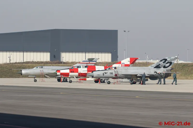 Three special MiG-21s are lined up on the flightline for our visit: while MiG-21R 26112 and MiG-21bisD 116 …
