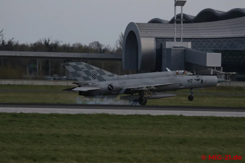 When the two MiG-21s finally land, the sun has disappeared completely behind the clouds, ...