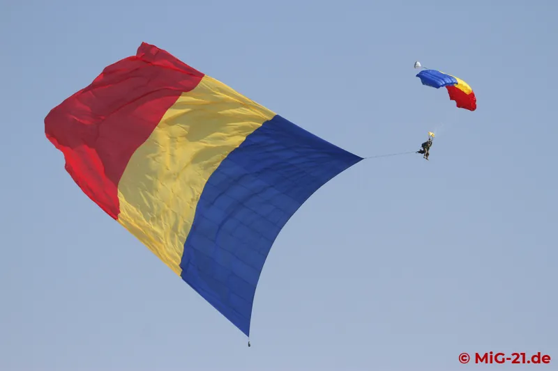 To leave no doubt in which country the event was taking place, parachutists jumped from a C-130 with a truly …