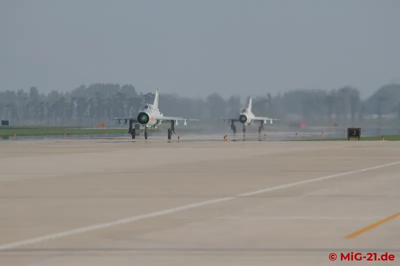 ... a MiG-21 finally appears at the end of the runway – and then another one.