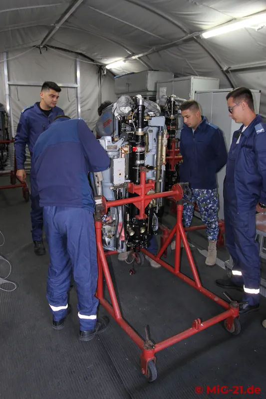 The ejection seat team works in a tent at the edge of the flightline ...