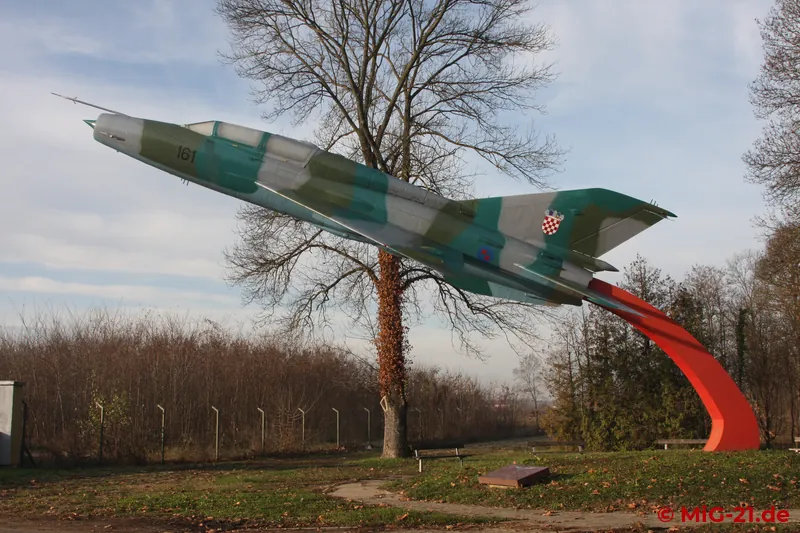 A MiG-21UM welcomes visitors at the entrance to the base.